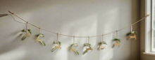 Load image into Gallery viewer, Handmade powder coated hanging gold reindeer garland measuring 150 x 22x 1cm
