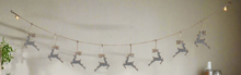 Load image into Gallery viewer, Handmade powder coated hanging silver reindeer garland measuring 150 x 22x 1cm
