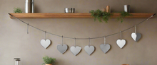 Load image into Gallery viewer, Handmade powder coated hanging silver heart garland measuring 150 x 20 x 1cm
