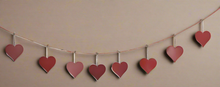 Laden Sie das Bild in den Galerie-Viewer, Handmade powder coated hanging red heart garland measuring 150 x 20 x 1cm
