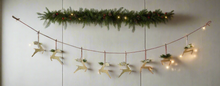 Load image into Gallery viewer, Handmade powder coated hanging gold reindeer garland measuring 150 x 22x 1cm
