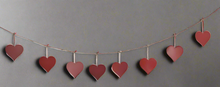 Load image into Gallery viewer, Handmade powder coated hanging red heart garland measuring 150 x 20 x 1cm
