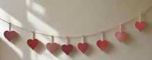 Load image into Gallery viewer, Handmade powder coated hanging red heart garland measuring 150 x 20 x 1cm
